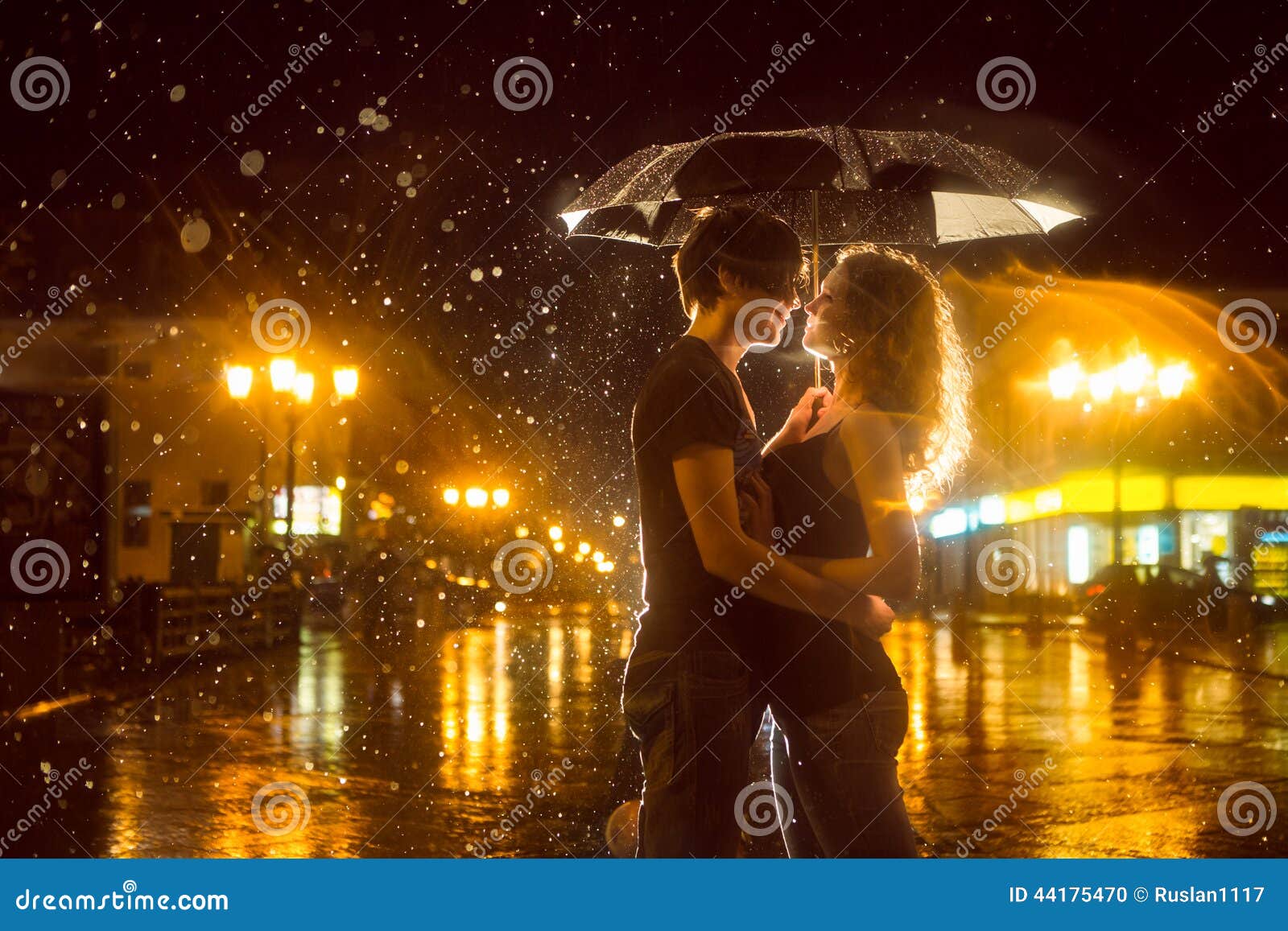 Girl boy kissing in rain